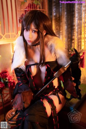 A woman in a black and red outfit holding two swords.