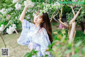 A woman in a blue and white kimono is posing for a picture.