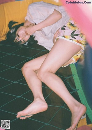 A woman sitting on top of a wooden chair.