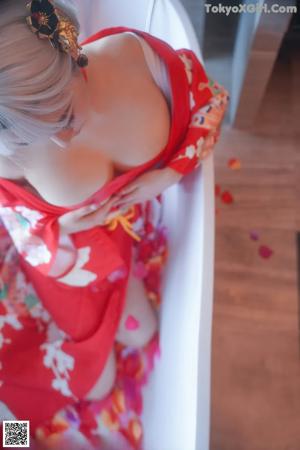 A woman in a red lingerie sitting in a bathtub.