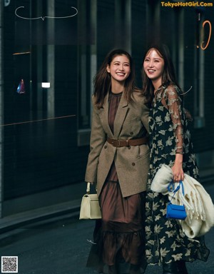 A couple of women standing next to each other in a magazine.