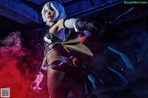 A woman dressed in a cosplay outfit holding a sword.