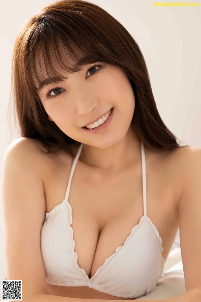 A woman in a white bra posing for a picture.