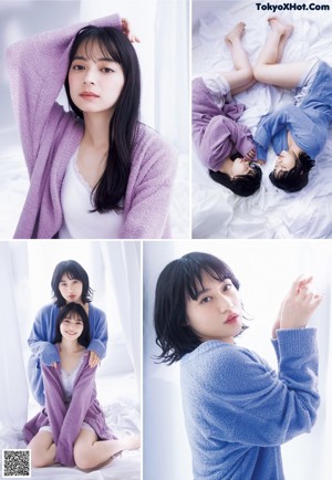 A couple of women laying on top of a bed.