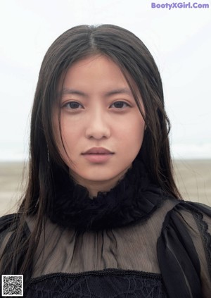 A woman with a sand dollar on her eye.