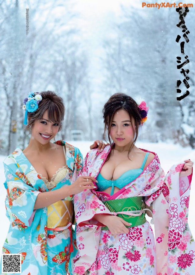 A couple of women in kimonos standing next to each other.