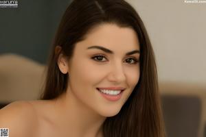 A nude woman sitting on top of a white couch.