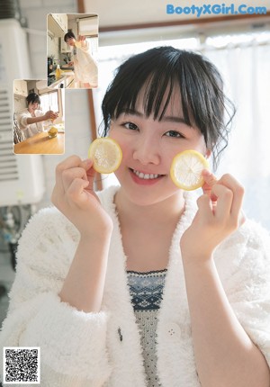 A woman in a school uniform is smiling for the camera.