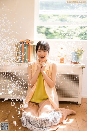 A woman holding a bouquet of flowers in her hands.