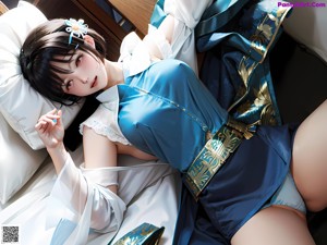 A woman in a kimono sitting on a bed next to a lamp.