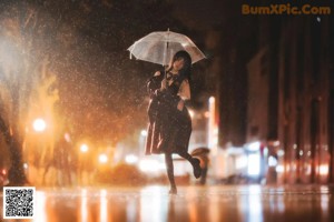 A woman holding an umbrella in the rain.