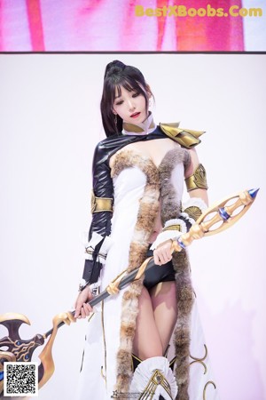 A woman dressed in a costume holding a sword.